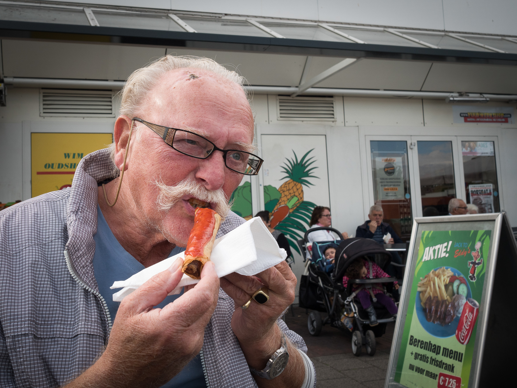 Moustached Man Eating a Lumpia