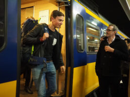 Student getting off a train at Leiden Centraal