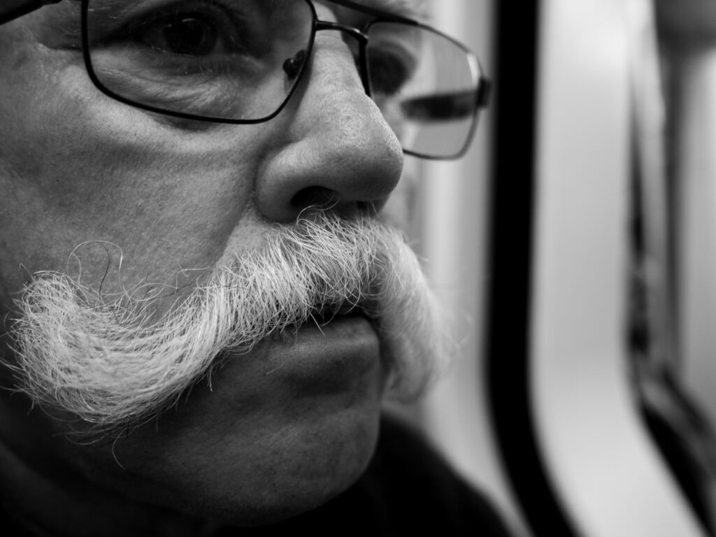 Tough man from Rotterdam wearing an impressive moustache. 

Picture taken in the Rotterdam underground on September 22, 2018