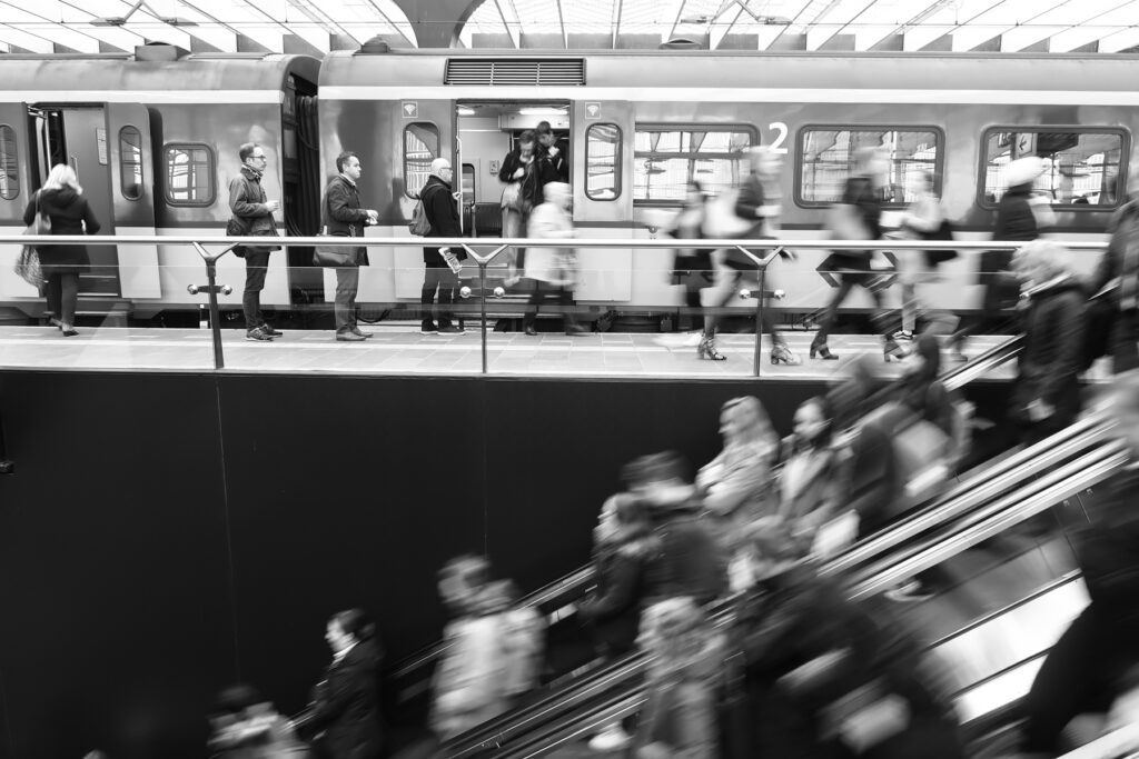 Commuters on an escalator.
