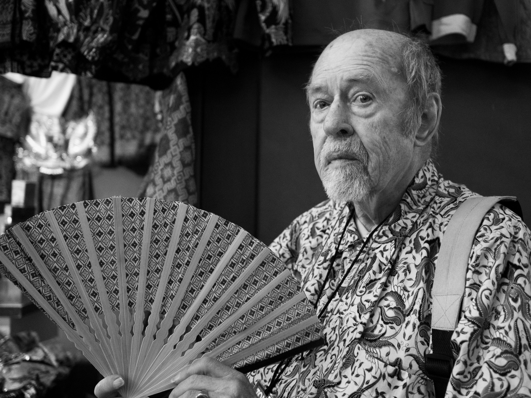 Senior Waving a Hand Fan